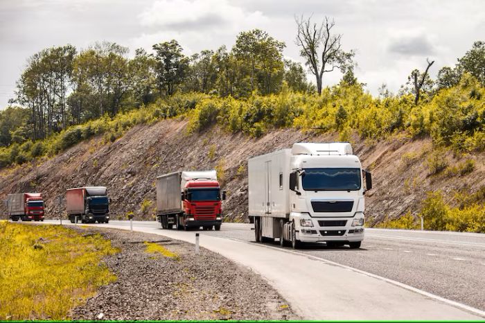 four-different-coloured-trucks-moving-by-road_470606-1147