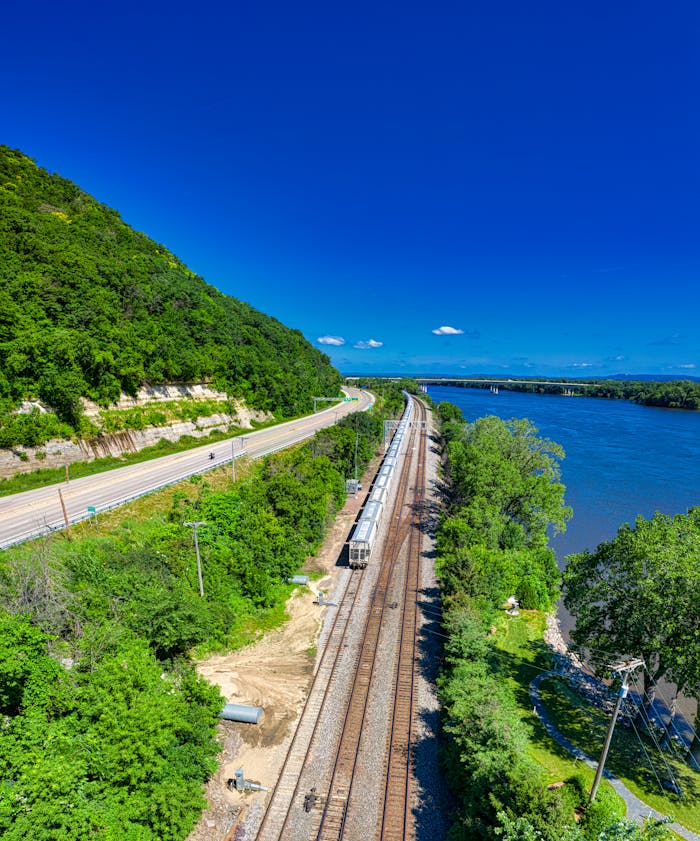 Aerial view capturing a train traversing along the scenic Mississippi River in La Crescent, MN.